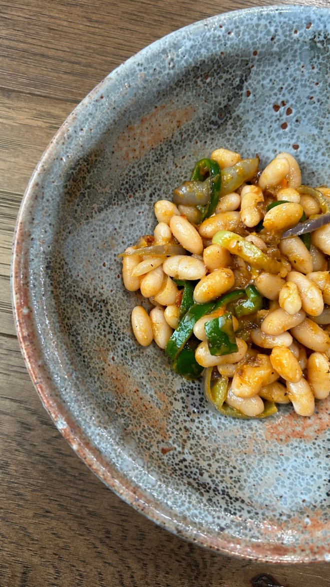 handmade bowl with white beans, peppers, soy chorizo tossed in tomato vinaigrette